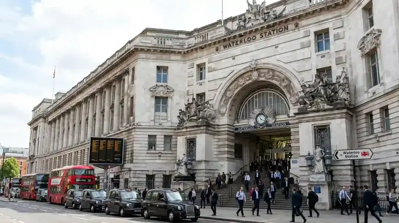 The grand stone Victory Arch entrance of Waterloo station with passengers outside